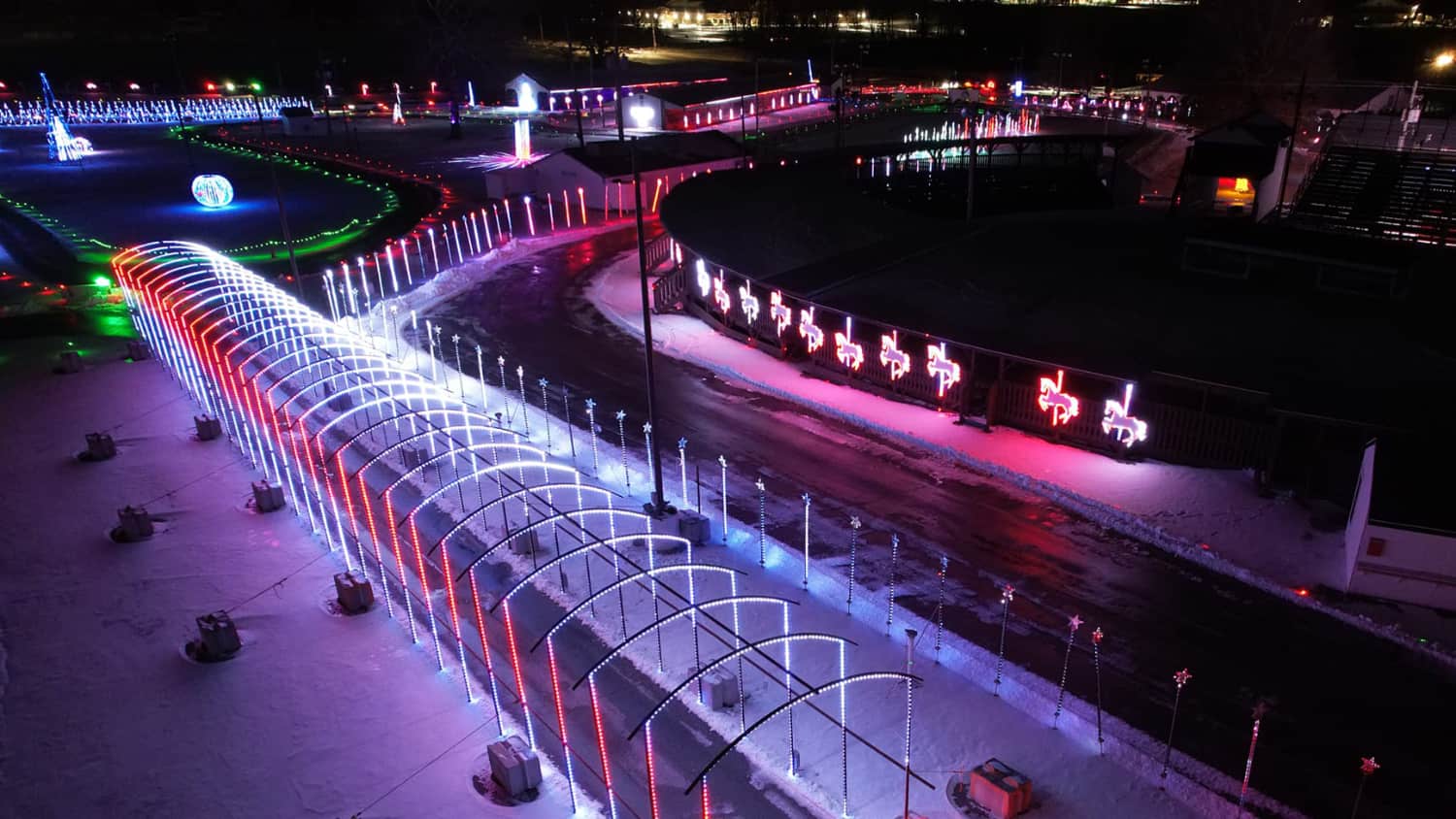 An aerial view of the glowing light tunnel and holiday displays at Light Up the Fair